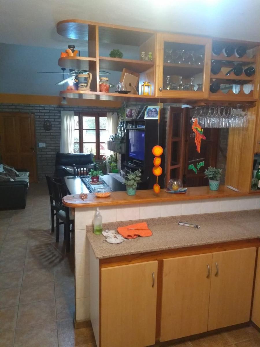 Excelente Chalet, listo para entrar, 2 dormitorios, Living-comedor con hogar a leña, cocina amplia, lavadero cubierto, quincho-cochera con deposito, aberturas de madera, techo con tejas. — foto 12